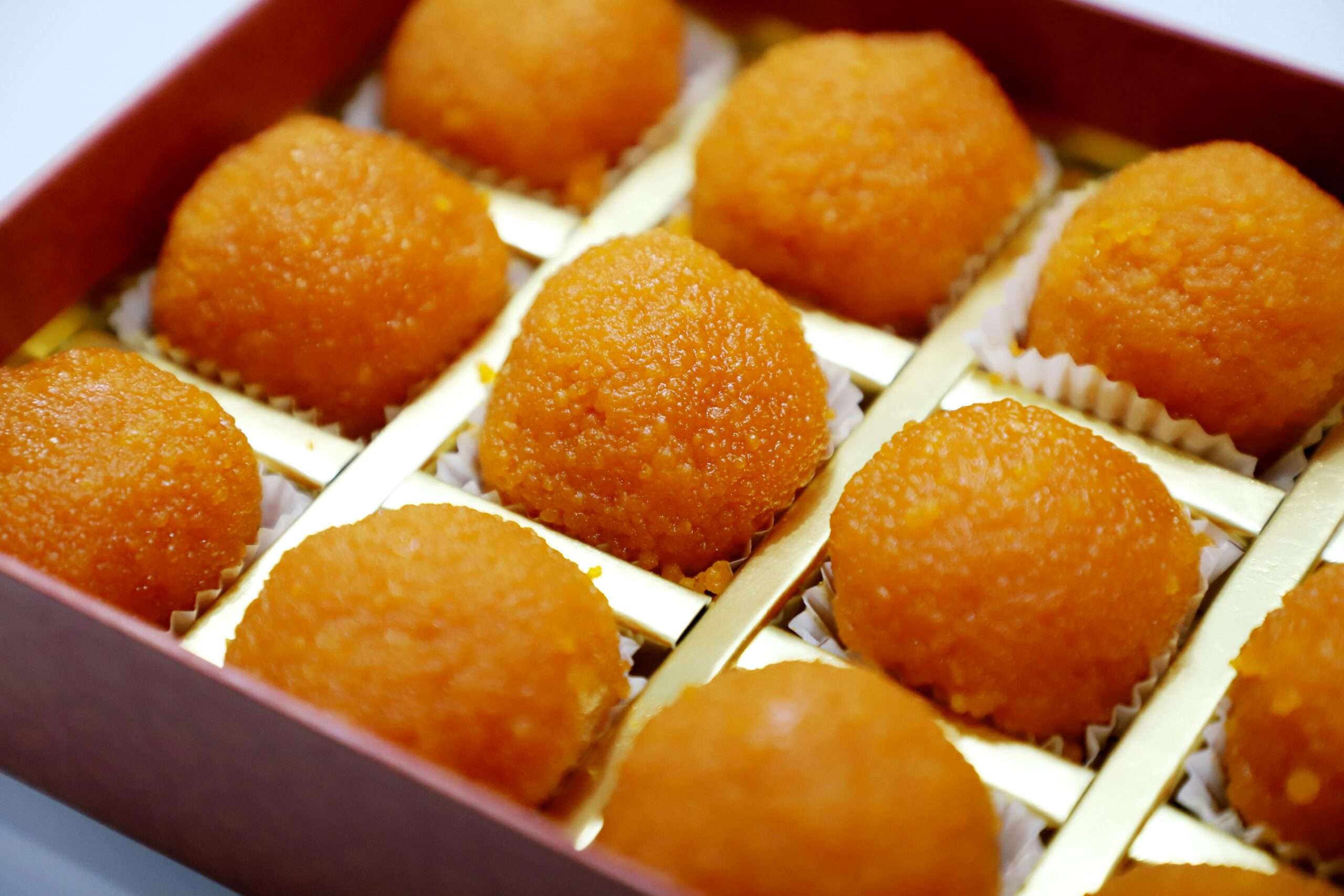 Delicious Indian laddoos in a box, perfect for celebrations and festive occasions.